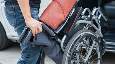 person lifting a manual wheelchair